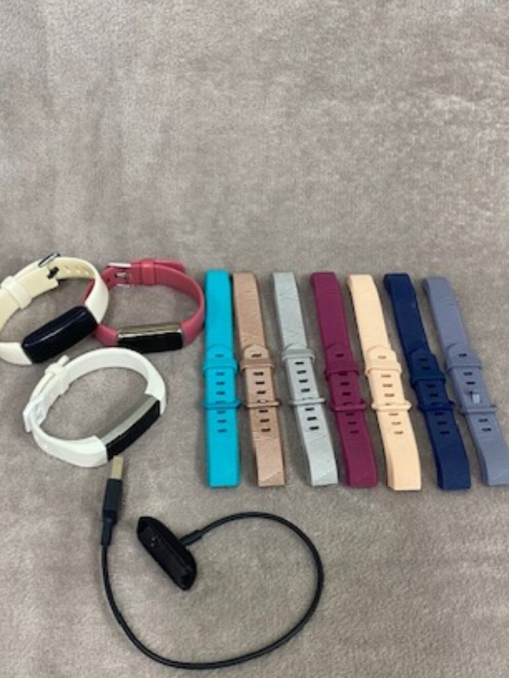 Fitbit Lot. 3 fitBits, one charger, 10 straps. Untested. Selling As Is